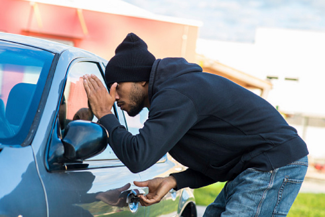 A thief attempting to steal a car Car Theft
