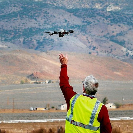 Man Reaching for Flying Drone