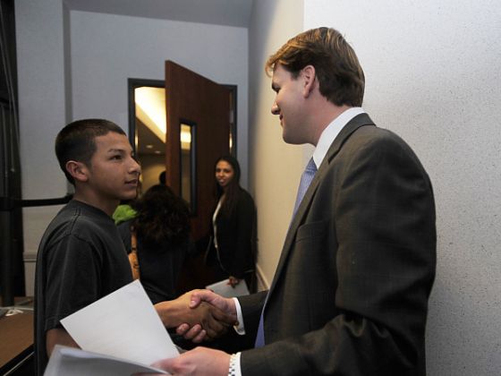 A polite child handshaking with a man Child Behavior