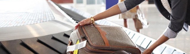Getting her bag after checking Checked Baggage
