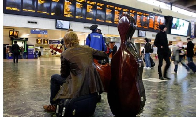 Man with his musical instrument in the airport Musical Instrument