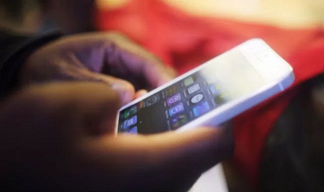 A man holding his iphone Holding an Iphone