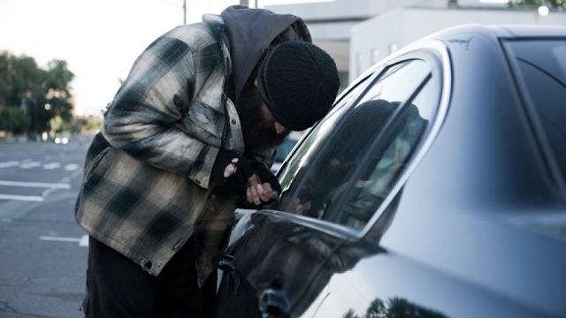 A thief about to steal a car Reducing Car Theft