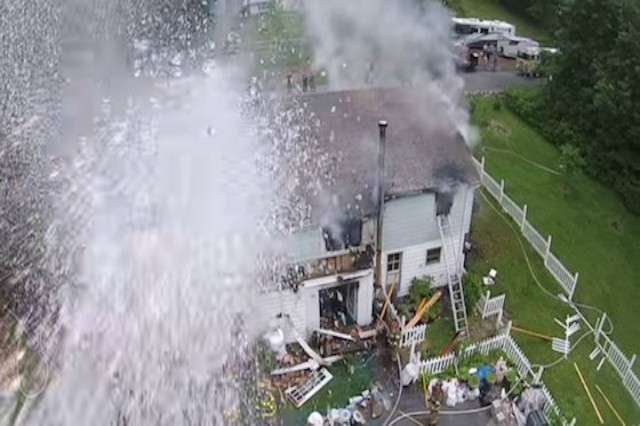 Firefighters Spurt Water at Drone