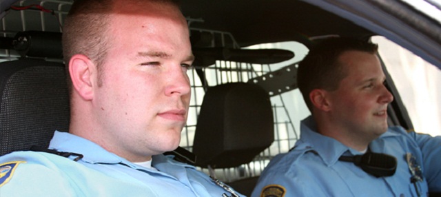 Two policemen in a car Police Officers