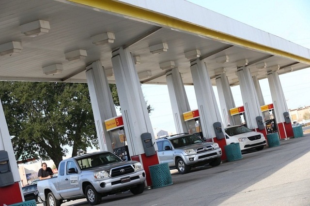 Government vehicles in a gasoline station Government Vehicles